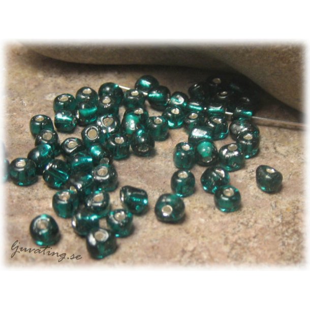 Petrol silverlined seedbeads i glas ca 4 mm